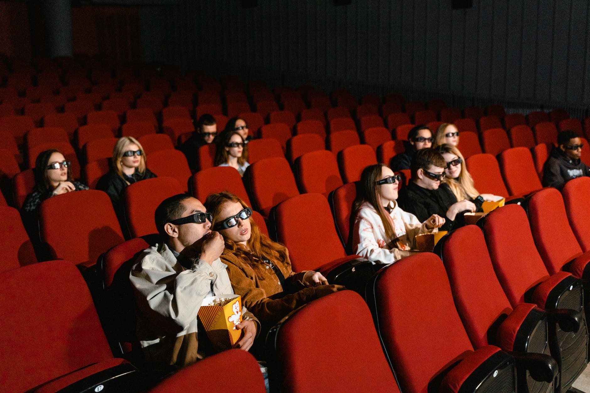 people sitting on red chairs